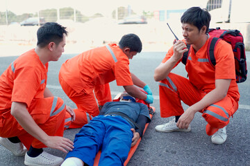 Emergency medical service team is rescuing Asian young man.