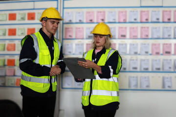 Blue-collar workers work at the KANBAN 
 delivery board at the warehouse.Supervisor and officer...