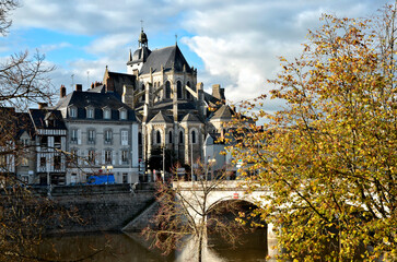 Town of Mayenne with the Notre-Dame basilica among foliage, commune in the Mayenne department in north-western France