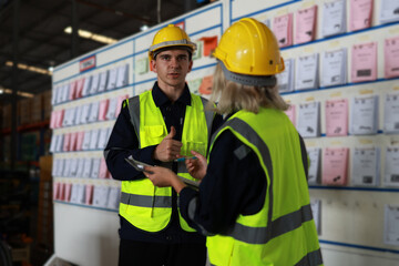 Blue-collar workers work at the KANBAN 
 delivery board at the warehouse.Supervisor and officer...
