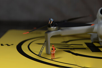 miniature figures checking the working of the drone propeller - 736347362