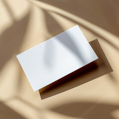 mock up of blank white business card on tan background, blank card element to place your design