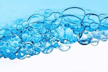 Close-up of bubbles in water, scientific background of cosmetic essence, serum under a microscope....