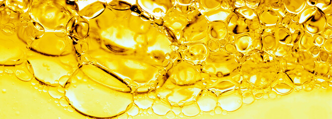 Transparent yellow bubbles in liquid. Cosmetic essence, serum. Oil in water, hydrophilic skin care....