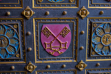 Fragment of the door to the neo-Gothic Cathedral of Saints Peter and Paul in the Visegrad Fortress in Prague. Coat of arms on the church door. This stunning church is the centerpiece of Visegrad.