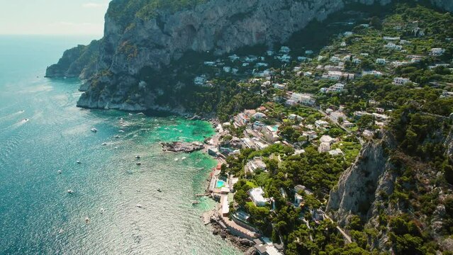 Aerial view of Capri Island with rugged coastline and azure Tyrrhenian Sea in summer Italy. Popular tourist attraction.