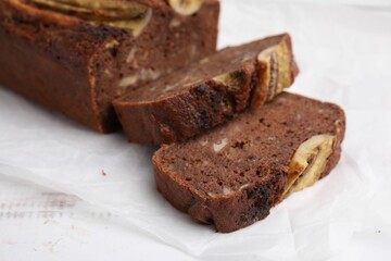 Delicious banana bread on white wooden table, closeup