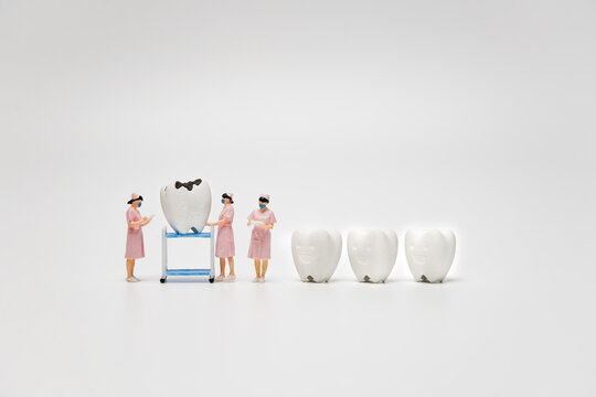 Figure cavity and decay teeth were forced nurse to checking dental examination and treatment with healthy tooth on white background