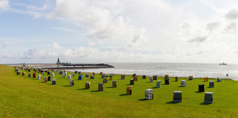 Panoramic photo of the coast of Cuxhaven Lower Saxony, Germany. Beach baskets on the North Sea