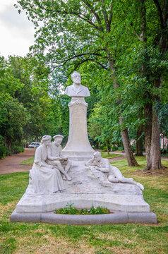 Amiens, France, July 3, 2023: Jules Verne Monument statue in Square Aime Cesaire park with green trees in Amiens city, Somme department, Hauts-de-France Region, Northern France