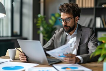 Obraz premium A man sits at a desk in an office, actively working on a laptop computer, An accountant deeply engrossed in auditing financial reports, AI Generated