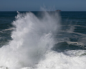 Big waves caused by the undertow crashing against the rocks at Rio de Janeiro, Brazil