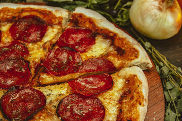 Delectable Pepperoni Pizza Surrounded by Fresh Ingredients