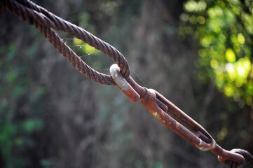 Old, decayed wire, rusted steel sling Rusted wire rope hanging from a bridge But still strong and usable