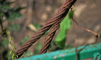 Old, decayed wire, rusted steel sling Rusted wire rope hanging from a bridge But still strong and usable