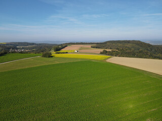 Aerial view of country fields with a blue sky in the countryside 