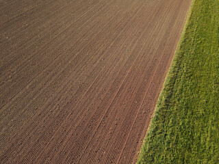 View from above of a farm field with soil in the countryside 