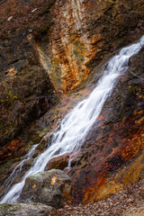 Fototapeta na wymiar Scenic waterfall in slow motion flow