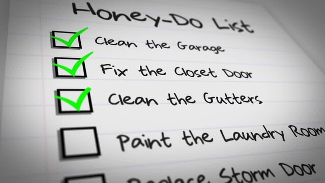 A close-up view of a wife's honey-do list for her husband with checkmarks.	