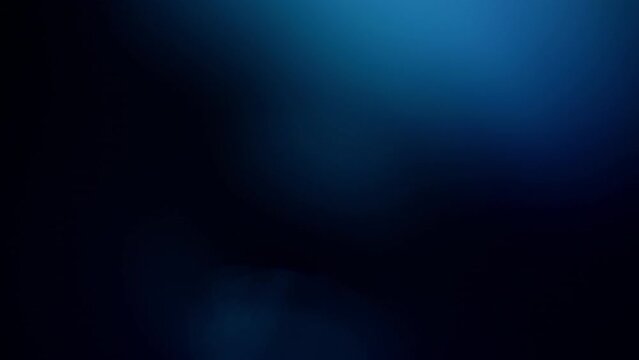 Defocused blue light reflections overlay on a black background