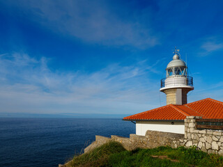 Fototapeta na wymiar The lighthouse of Suances in Cantabria, Spain, photographed on a sunny day.