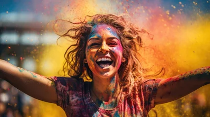 Fototapeten young woman celebrating holi festival outdoors. Fun with colours. A vibrant splash of colors © Ilmi