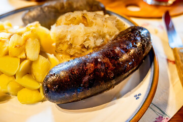 Black pudding (sausage) with cabbage and potato, closeup. - 736427977