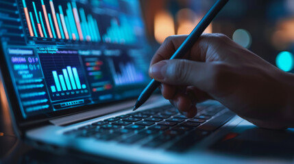 person's hand is holding a stylus over a laptop screen displaying various colorful data analytics and graphs.