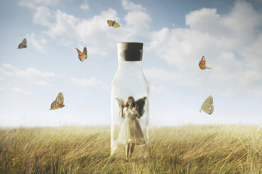 the surreal butterfly woman looking at the freedom enclosed in a bottle, abstract concept