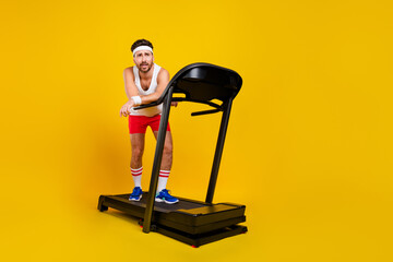 Full size portrait of sportive tired handsome man stand treadmill equipment empty space isolated on...