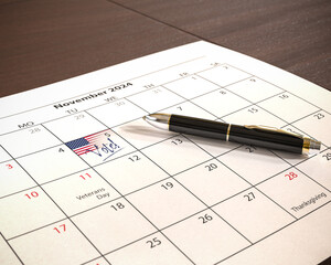 US presidential election will take place on November 5, 2024. A calendar with a US flag and the text "Vote!" at the 5th of November. A pen lying on the calendar sheet.