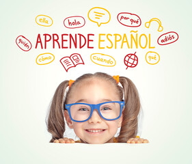 Beautiful cute little girl with eyeglasses looking at  Learn Spanish text in Spanish and...