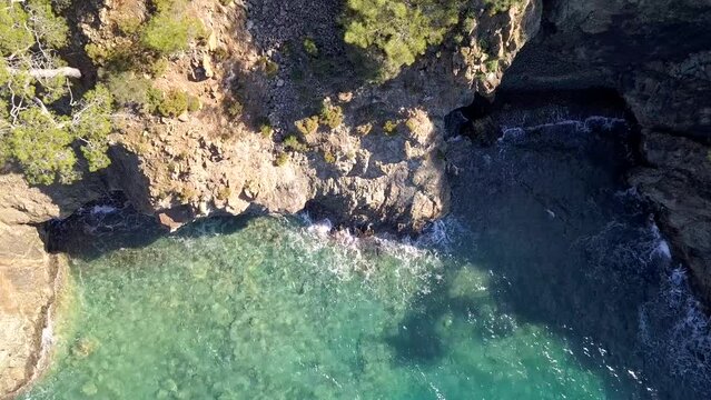 Captivating Coastline: Drone Video of Waves Crashing Against Rock at Seashore
