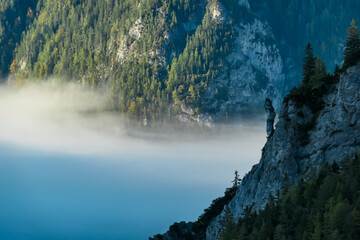 Unique rock formation overlooking fog covered valley in untamed Hochschwab mountain region, Styria,...