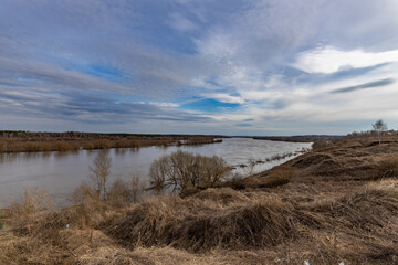 early spring flood, high water in the countryside, river overflowing its banks, trees in the water, flooded banks, environmental pollution, ecology