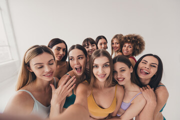 No filter studio photo of funny pretty women wear recording video accepting imperfect skin isolated beige color wall background