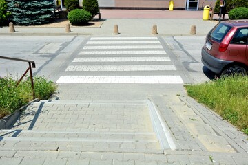 Stairs leading straight to the pedestrian crossing lanes on the road