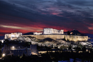 Panorama of Acropolis hill at night, Athens, Greece. Famous old Acropolis is a top landmark of Athens. Ancient Greek ruins in the Athens center at dusk
