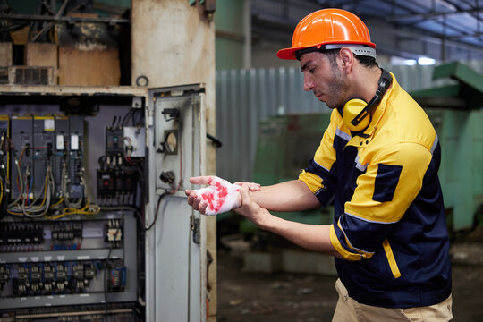 worker or engineer injured hand with bandage from accident in the factory