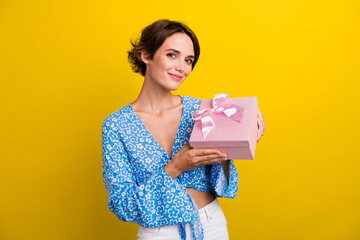 Photo of pretty adorable woman wear flower print blouse holding pink present box isolated yellow color background - obrazy, fototapety, plakaty