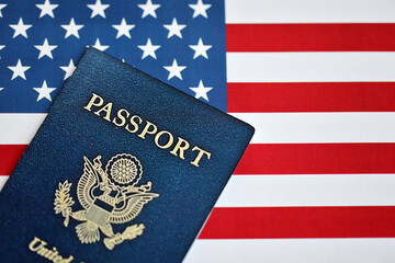 New Blue United States of America Passport on US Flag background. Concept of obtaining US...