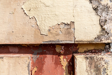 Abstract textures of the close up detail of peeling paint and plaster of an old building in Margao.