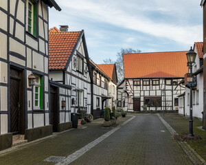 Fototapeta na wymiar Typical medieval old town with half-timbered houses in Altesdorf Westerholt in Germany