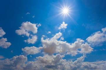 sparkle sun on blue cloudy sky natural background