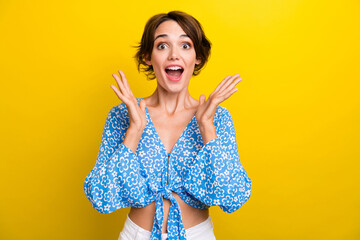 Photo of impressed funky young woman wear flower print blouse rising hands arms open mouth isolated...