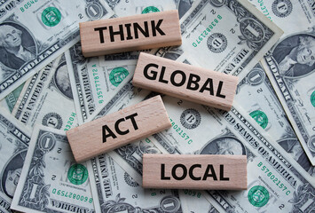Think global act local symbol. Wooden blocks with words Think global act local. Beautiful dollar...