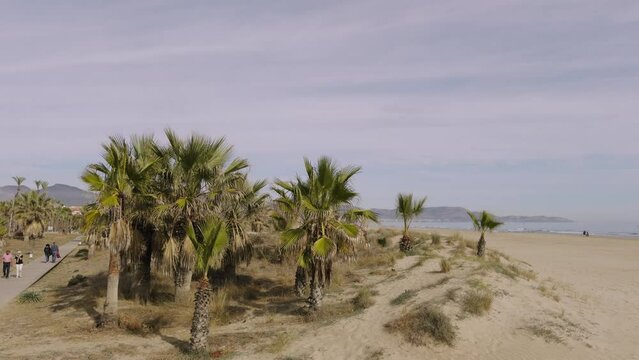 A walk on a sandy beach in Spain. A warm winter day in the sand dunes of Grao. Castellon