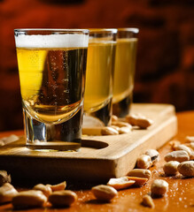 Glasses with fresh beer and pistachio on the table. Shallow depth of field