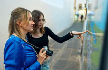 Female tourists studies a map of the old city.