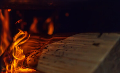 A log burns in the stove